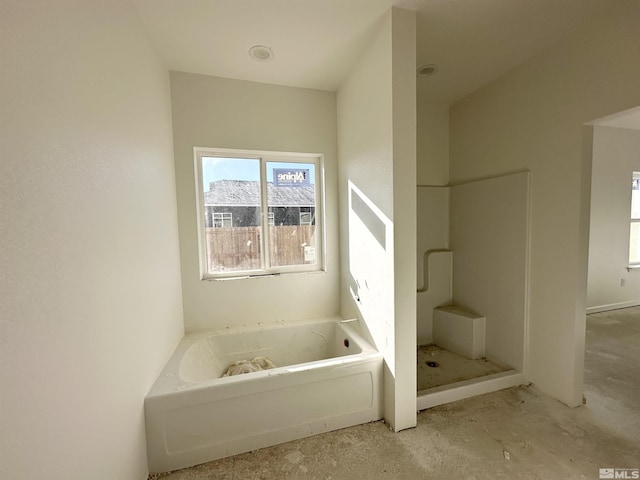 bathroom with a tub to relax in