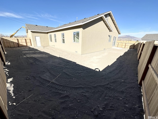 back of property featuring a mountain view