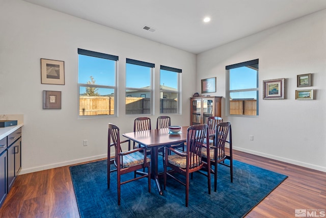 dining room with dark hardwood / wood-style flooring