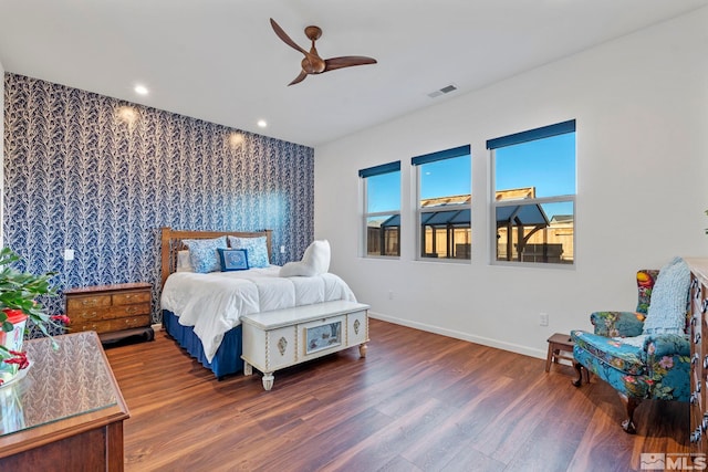 bedroom with ceiling fan and dark hardwood / wood-style flooring