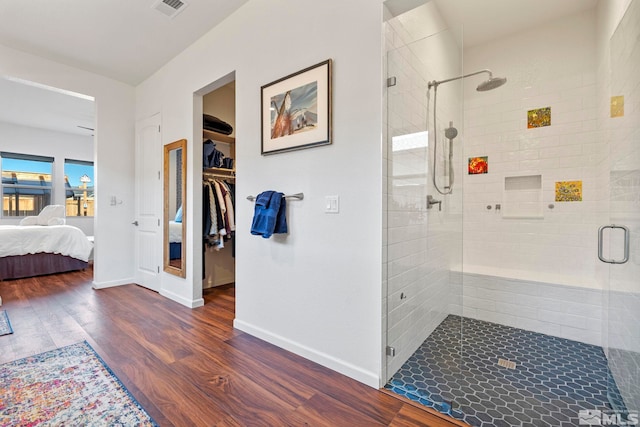 bathroom featuring hardwood / wood-style floors and an enclosed shower