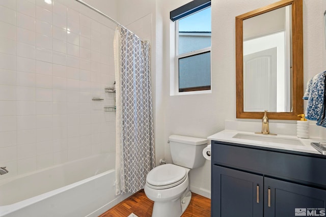 full bathroom with toilet, shower / bath combo with shower curtain, vanity, and hardwood / wood-style flooring