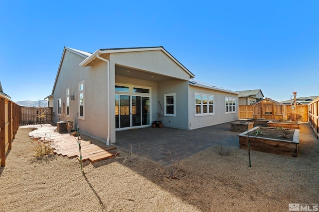 back of house featuring central air condition unit