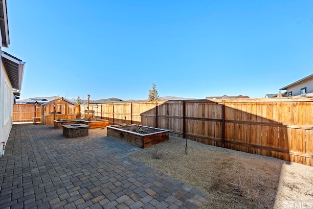 view of patio / terrace featuring a fire pit and a shed