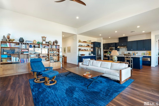 living room with ceiling fan, sink, and dark hardwood / wood-style floors