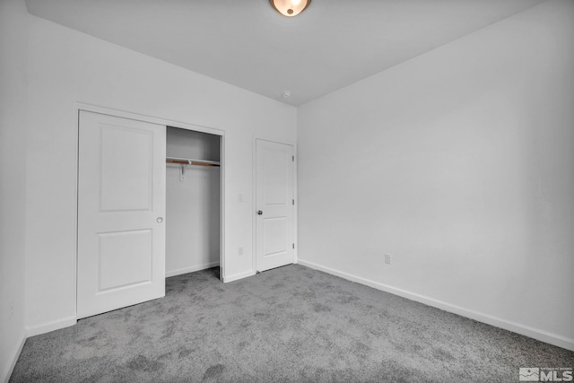 unfurnished bedroom with carpet floors and a closet