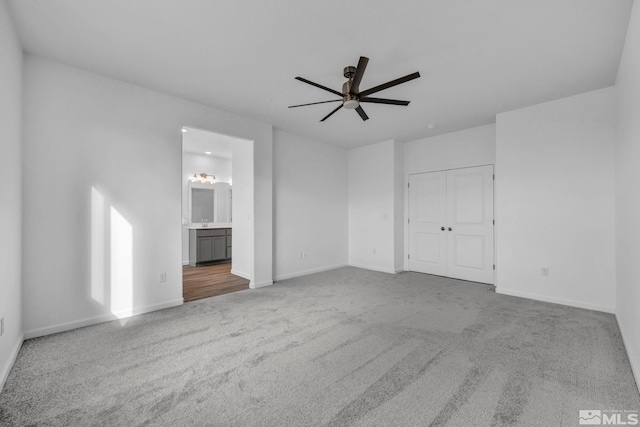 interior space featuring ceiling fan, carpet floors, and sink