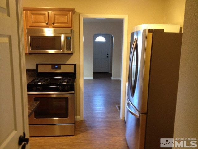 kitchen featuring dark hardwood / wood-style flooring and appliances with stainless steel finishes