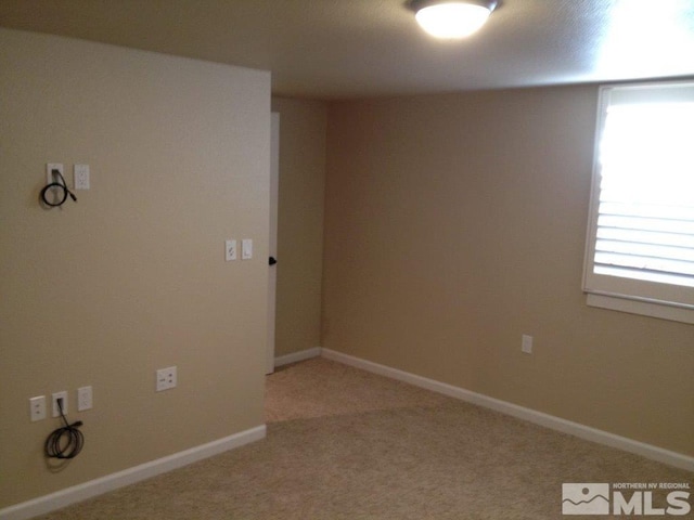 carpeted empty room with a healthy amount of sunlight