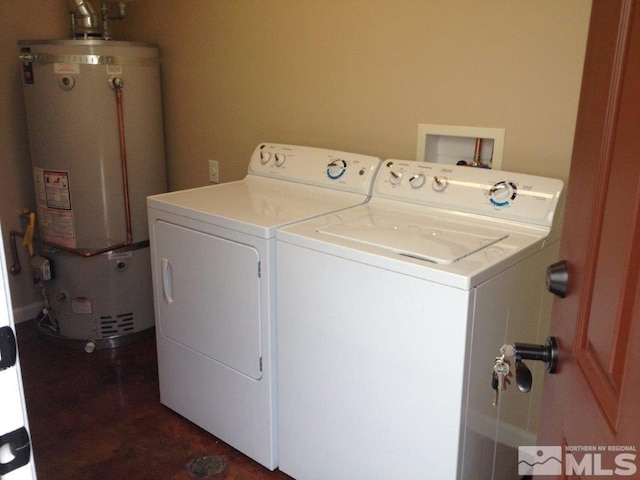 clothes washing area featuring washing machine and dryer and gas water heater