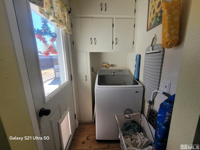 washroom featuring cabinets, dark hardwood / wood-style floors, and washer / dryer