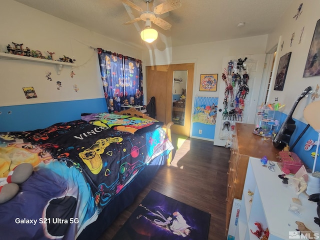 bedroom featuring ceiling fan, dark hardwood / wood-style flooring, and a textured ceiling