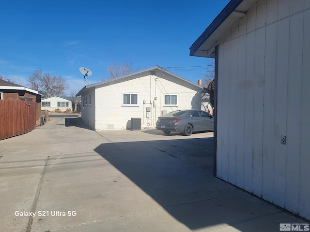 view of side of property with central AC