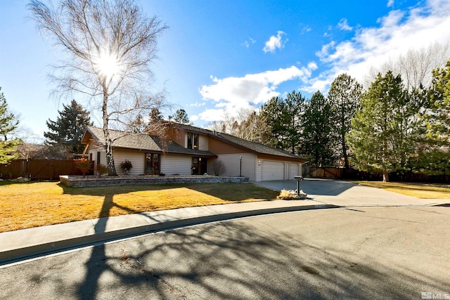 ranch-style home featuring a front lawn and a garage