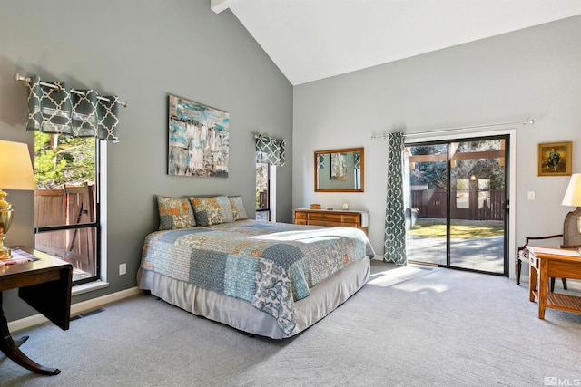 carpeted bedroom with access to outside, beamed ceiling, and high vaulted ceiling