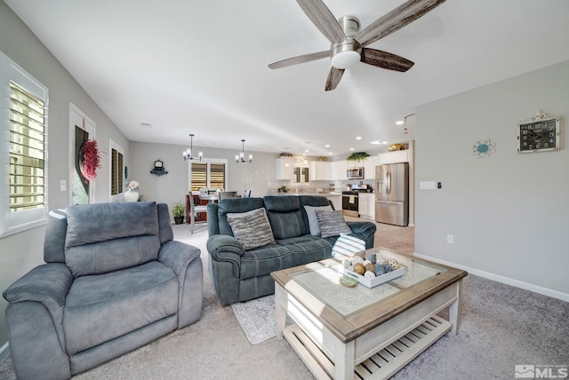 living room featuring light carpet and ceiling fan with notable chandelier