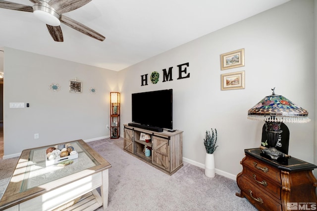 carpeted living room with ceiling fan