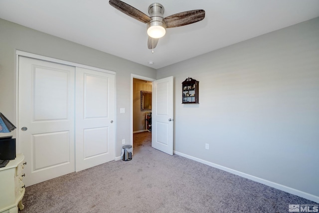 unfurnished bedroom with ceiling fan, light carpet, and a closet