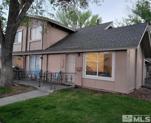 rear view of house with a lawn