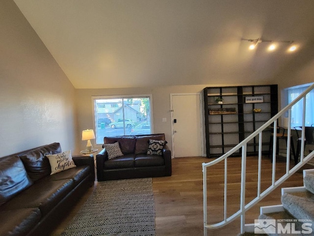 living room featuring vaulted ceiling and hardwood / wood-style flooring