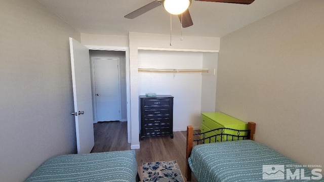 bedroom featuring ceiling fan, dark wood-type flooring, and a closet