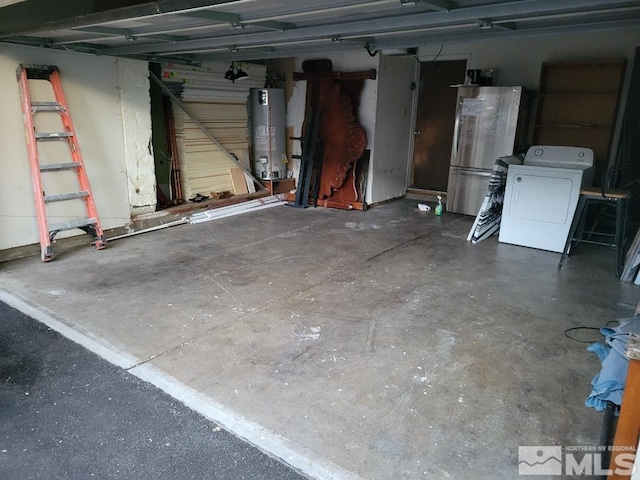 garage with stainless steel refrigerator, water heater, and washer / dryer