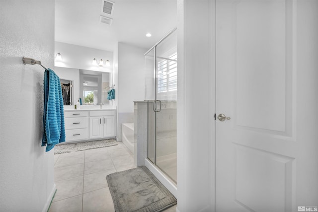 bathroom featuring tile patterned floors, vanity, and shower with separate bathtub