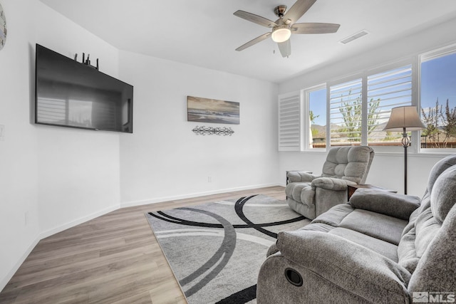 living room with ceiling fan and hardwood / wood-style floors