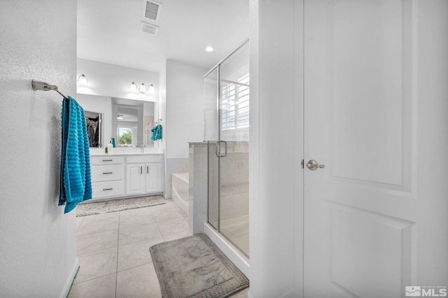 bathroom with tile patterned floors, vanity, separate shower and tub, and plenty of natural light