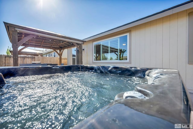 view of pool with a hot tub