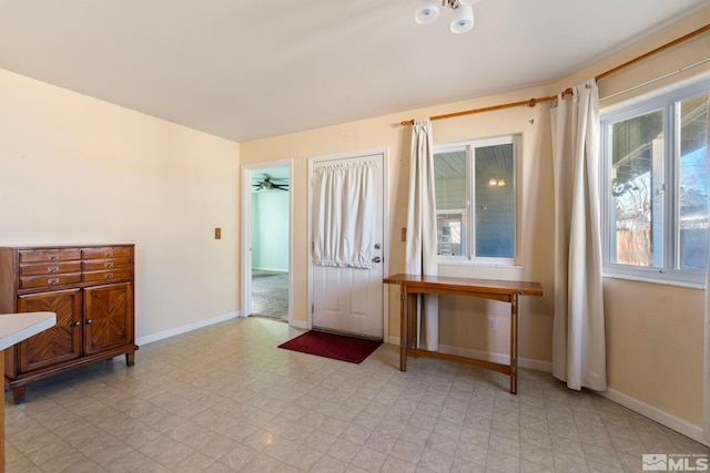 interior space with ceiling fan