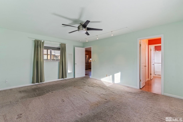 unfurnished room with ceiling fan and light colored carpet