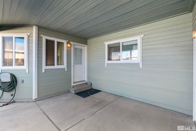 entrance to property featuring a patio