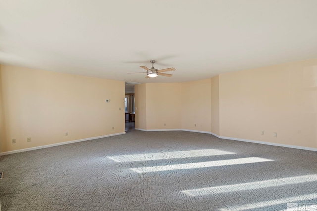 carpeted spare room featuring ceiling fan