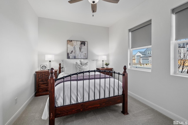 bedroom with carpet flooring, ceiling fan, and multiple windows