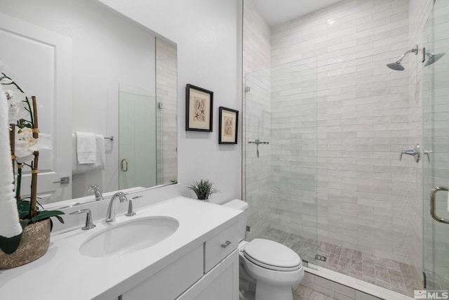 bathroom with vanity, toilet, and an enclosed shower