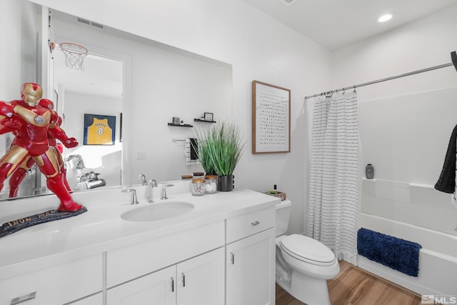 full bathroom featuring shower / tub combo with curtain, vanity, wood-type flooring, and toilet