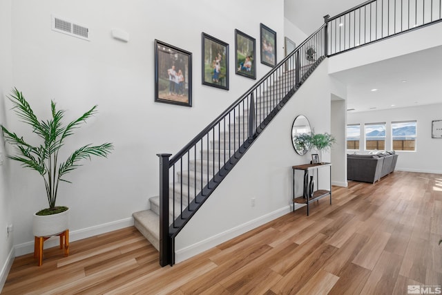 stairway with hardwood / wood-style floors