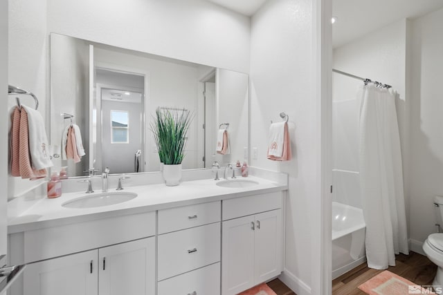 full bathroom with wood-type flooring, vanity, toilet, and shower / bathtub combination with curtain