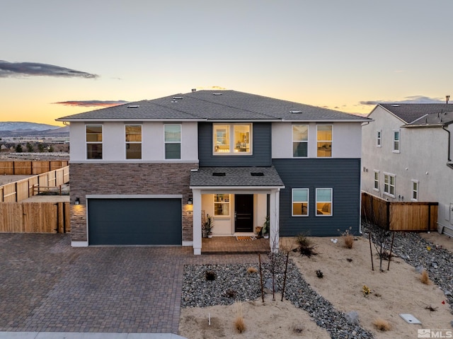 view of front of home featuring a mountain view and a garage