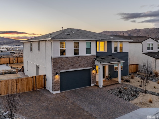 view of front of property with a mountain view and a garage