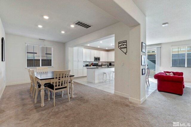 dining space with light carpet