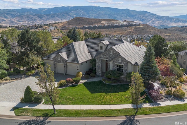 exterior space with a mountain view, a front yard, and a garage