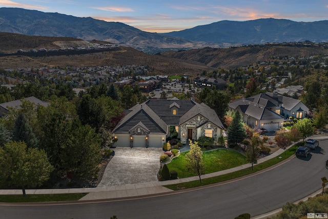 aerial view at dusk featuring a mountain view