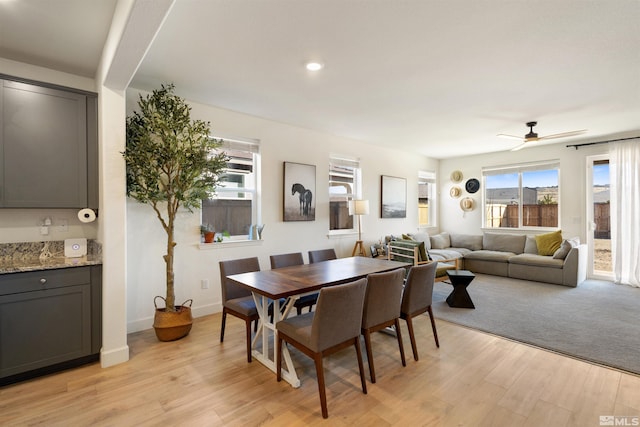 dining room with ceiling fan and light hardwood / wood-style flooring