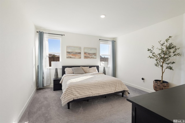 carpeted bedroom featuring multiple windows