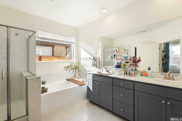 bathroom with tile patterned flooring, vanity, and separate shower and tub