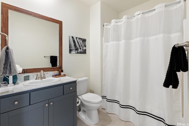 bathroom featuring tile patterned floors, vanity, and toilet