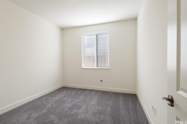 unfurnished room featuring dark colored carpet