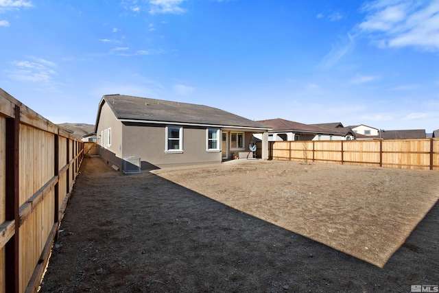 rear view of house with central AC